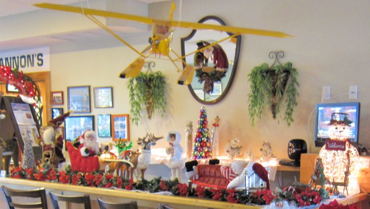 A model Piper Cub is displayed about some of C.J. Cannon's festive holiday decorations. Located in the Vero Beach Airport terminal building, C.J. Cannon's advertises that "the only thing we overlook is the runway."  