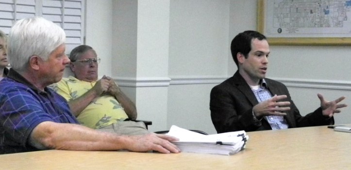 City Manager Jim O'Connor, proposed sales agreement in hand, listens as FPL negotiator Ryan Fair explains the deal to Councilman Jay Kramer