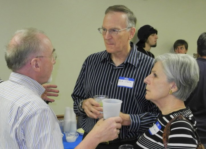 Incoming Rotary district governor, Frank Ehlers of Germany, visits with Richard and Betty Carlin at a barbecue held Saturday evening at the River House.