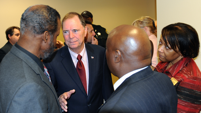 Fred Wilfork, Lindel Williams and Angela Perry, of the Gifford Youth Activity Center, speak with Congressman Bill Posey at the opening of  the congressman's new office Tuesday.