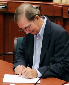 Craig Fletcher signs the contract with FPL. 