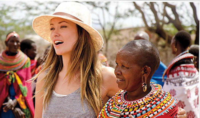 Olivia Wilde learns how to make beaded jewelery with women from Umoja Women's Village in Samburu, Kenya.