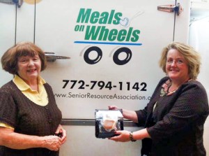 Trish Scattergood with the Vero Beach Rotary Club on hand with Laura Roberts, SRA Director of Nutrition Services loading holiday meals into the Meals on Wheels truck.