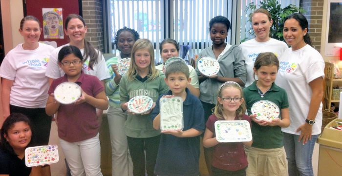 Whole Child committee members and Highlands students proudly show off their stepping stones. Back row: Committee members Sarah Cobb and Genevieve Introcaso, Highlands students Nancy Dorcely, Mariah Zeh and Kayla Anderson, and committee members Elizabeth Swann and Jennifer Bickford. Front row: Lily Tran, Myky Duong, Cassidy Blair, Dawson Proffit, Rylee Fannin, and Grace Mendez