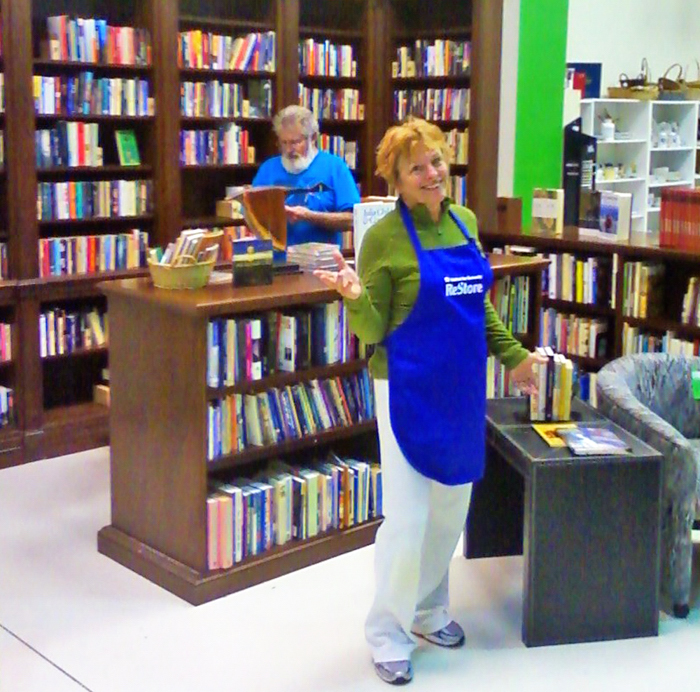 Carolynn Nemeth shows off  her newly remodeled library. Customer Jim Gorman, looking on, proclaimed, “You have the best travel section in town!”