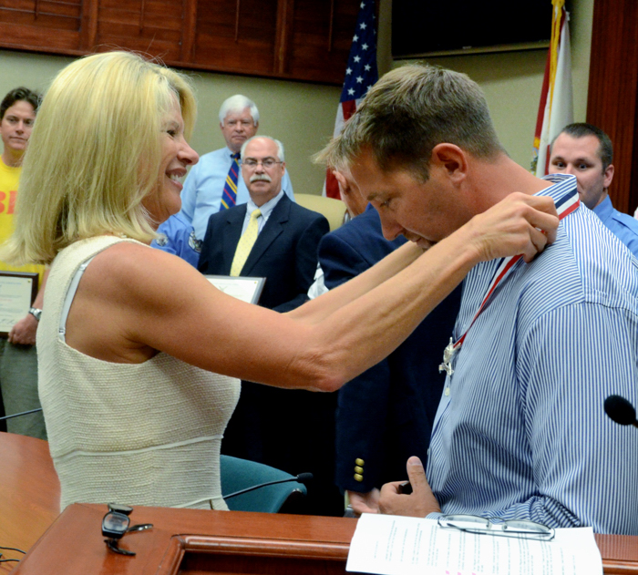 State Representative Debbie Mayfield City of Vero Beach lifeguard Eric Toomsoo was awarded the U'S. Lifeguard Association's Medal of Valor today for his role in rescuing German tourist Karin Stei during a share attach off Humiston Beach Park May 9, 2012.