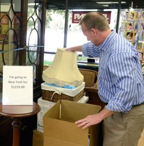 Phil DeLange inspects items to be shipped from his Pak Mail location on Beachland Boulevard.