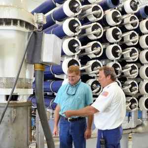 Vero Beach Water and Sewer Utility Director Rob Bolton, left, and water treatment plant operator Jeff Howard inspect the city’s reverse osmosis water filtration system