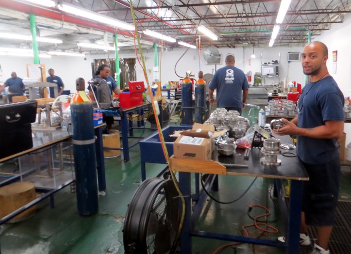 workers in the finishing room prepare valve assemblies for final inspection.