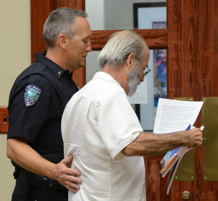 Brian Heady escorted from the lectern at last night's Council meeting.