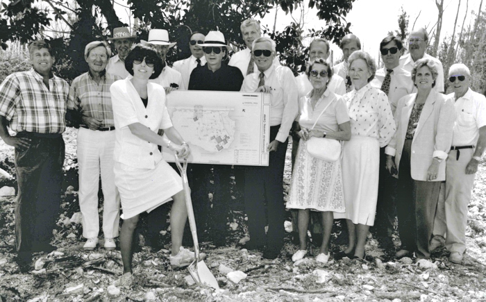 Surrounded by the Board of Trustees and other stakeholders, Holly Dill leads the groundbreaking ceremony for the ELC in the fall of 1991.