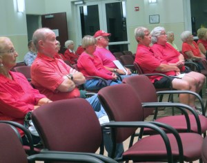 Small group of grim red shirted anti-Seven50 protestors at Sebastian City Council meeting.