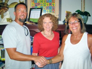 Sealing the 501-C-3 partnership for the Poolside Pavilion at Leisure Square are (left to right): Erik Toomsoo-Vero Beach Lifeguard Association, Kerry Bartlett-IRC Community Foundation and Beverly Paris-Volunteer Group Chair.