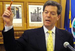 After four years of cutting taxes and state spending, Kansas Gov.Sam Brownback faces a revolt from within the Republican Party.  JOHN HANNA/AP