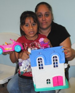 Mother Selina Bargas and five year old daughter Yartica select some special toys from the Giving Closet.