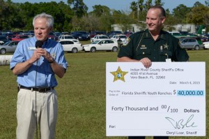 Indian River County Sheriff Deryl Loar presents a donation check to Florida Sheriff's Youth Ranches President Bill Frye.