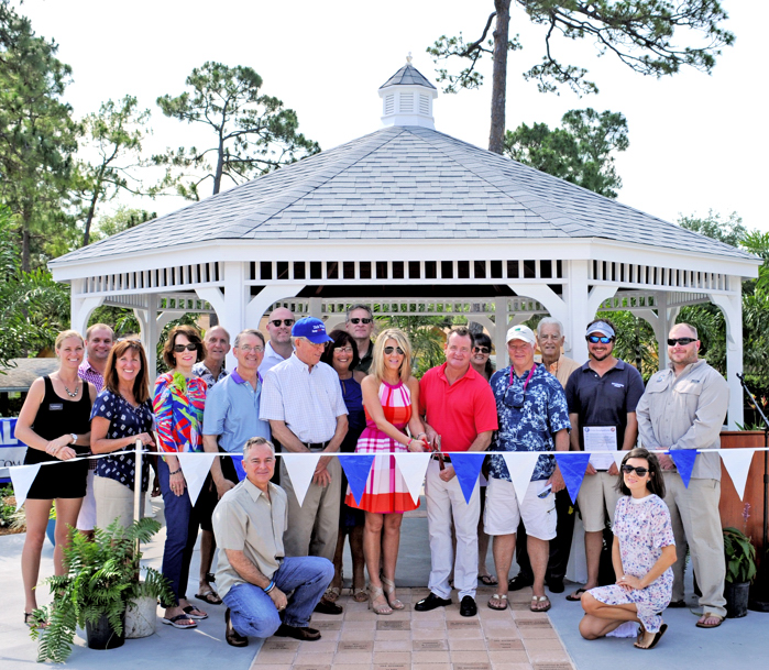 Joining Tim Girard and Jackie Savell (center) who officially cut the ribbon, were Vero Beach city officials and the volunteer Pavilion committee members.