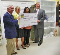 Hope Foundation president Warren L. Schwerin presenting a $10,000 check to (l to r) Dasie Hope Center Board member Michael Joy Hauser, Executive Director Verna Wright, and Board president Sheriff Deryl Loar.]